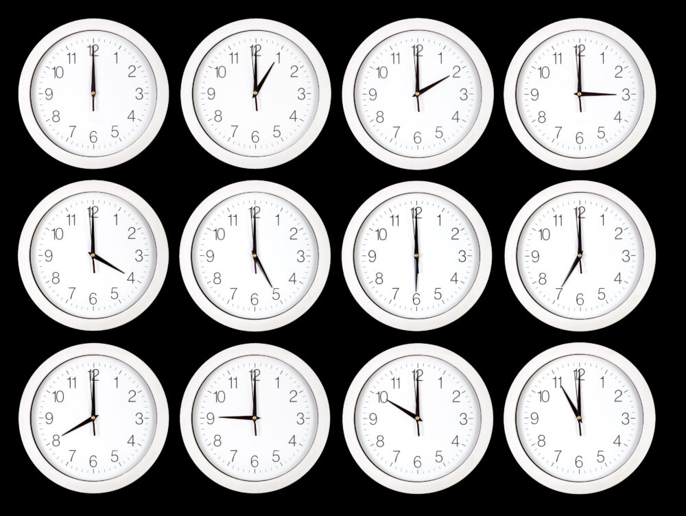 Set of white clock faces on black background