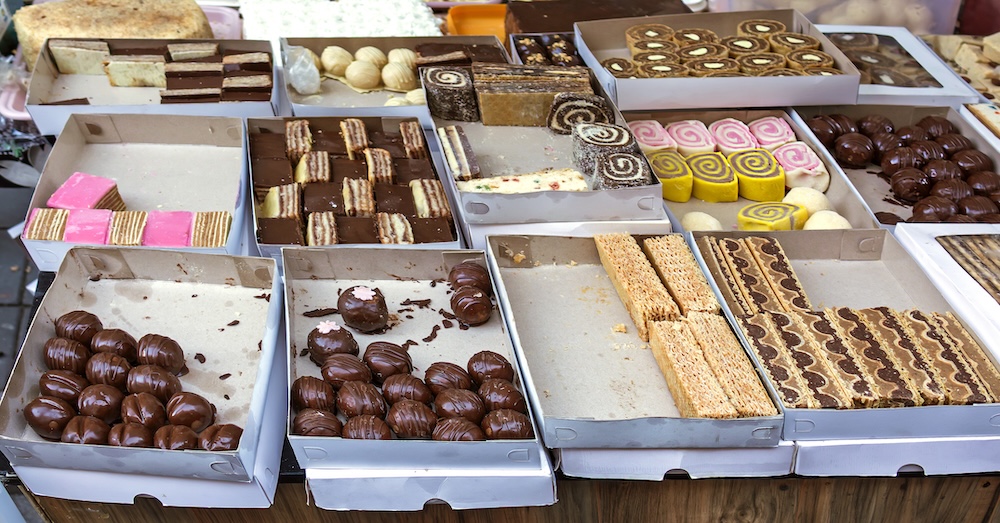 Sweet homemade cake deserts in boxes sold on market outside
